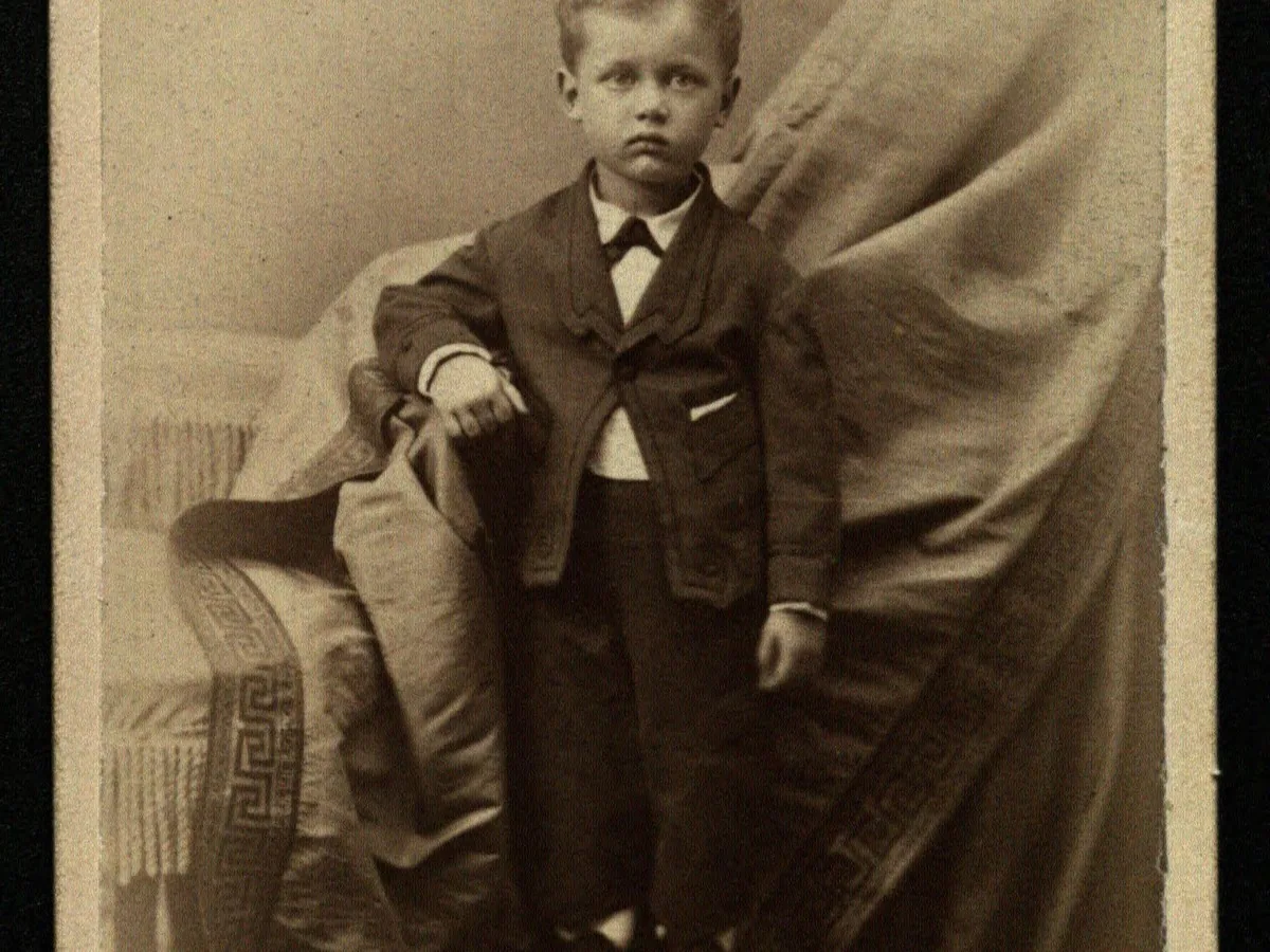 Faded cabinet card of a young boy, before enhancement