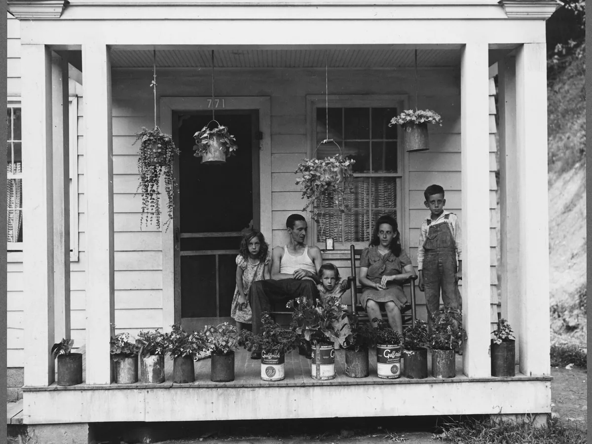 A miner's family on their porch, before enhancement
