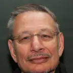 Portrait with window glare on his eyeglasses