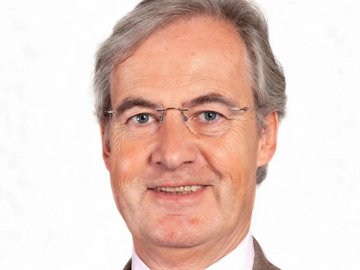Man with window reflections on his rimless glasses, after enhancement