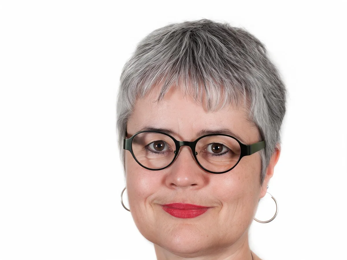 Woman with flash glare on her round glasses, after enhancement