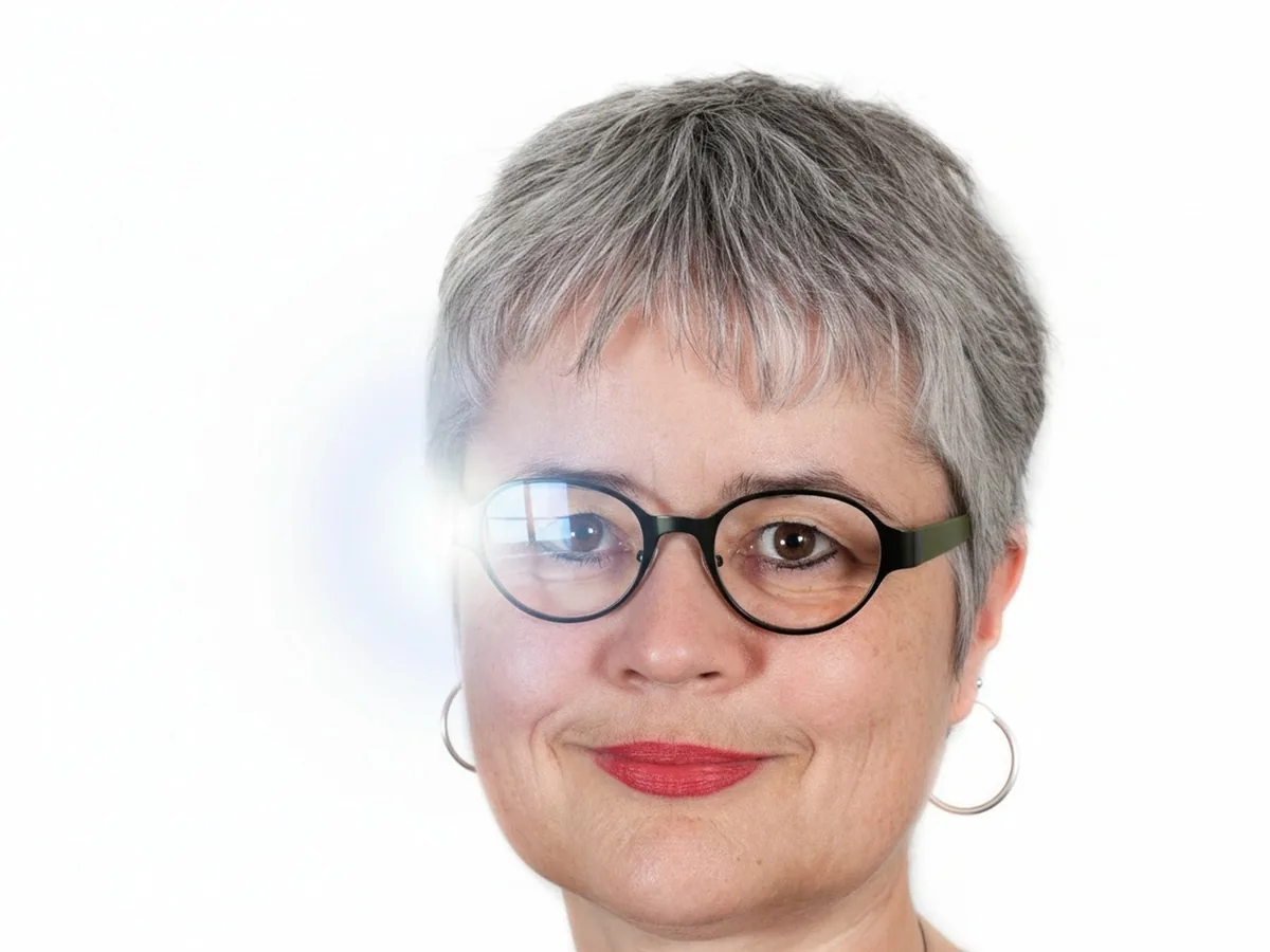 Woman with flash glare on her round glasses, before enhancement