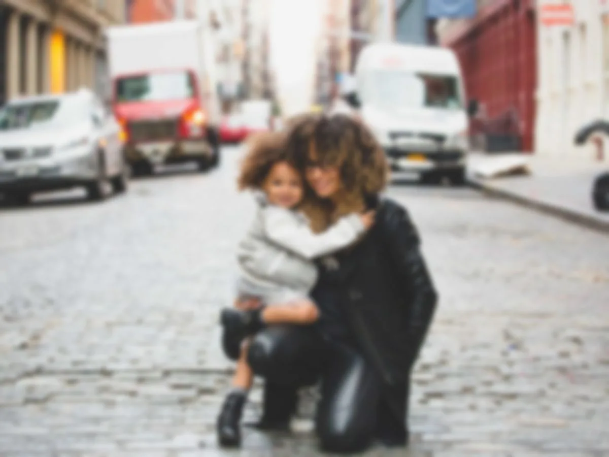 Out-of-focus street photo of a mother and child, Before