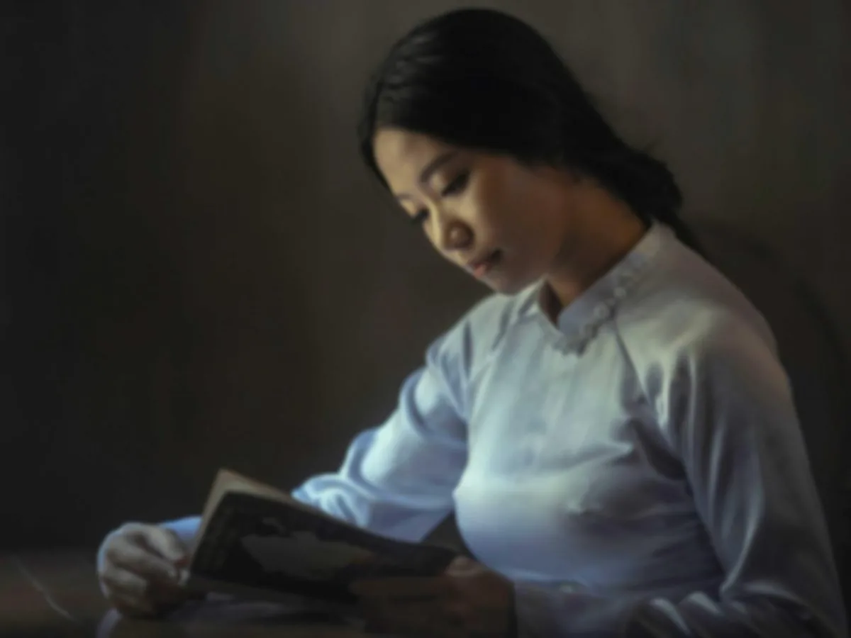 Out-of-focus photo of a woman reading, before enhancement